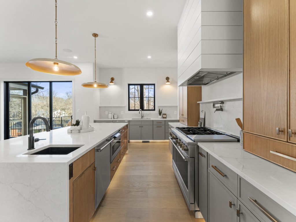 Modern chef’s kitchen with quartz countertops, custom cabinetry, and statement pendant lighting