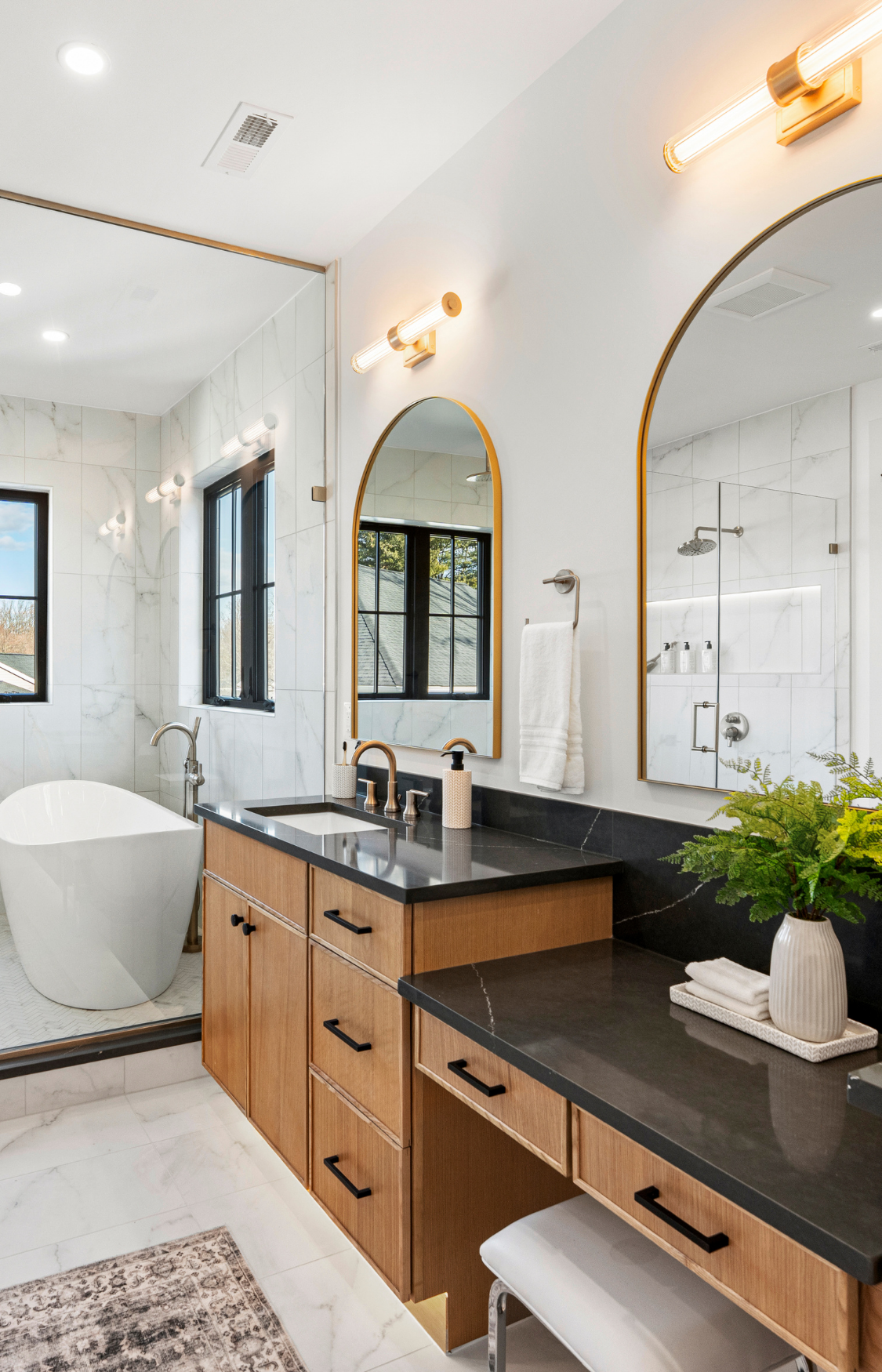 Spa-inspired bathroom remodel with walk-in glass shower, floating vanity, and marble-look tile