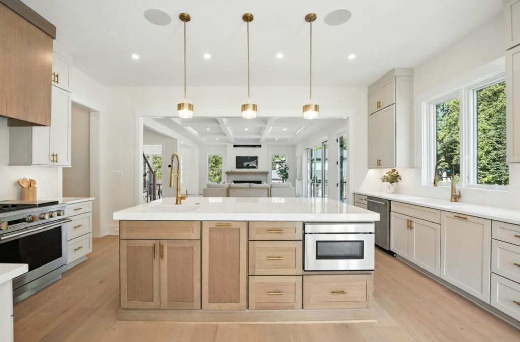 Modern kitchen remodel with large island, white cabinetry, and natural light