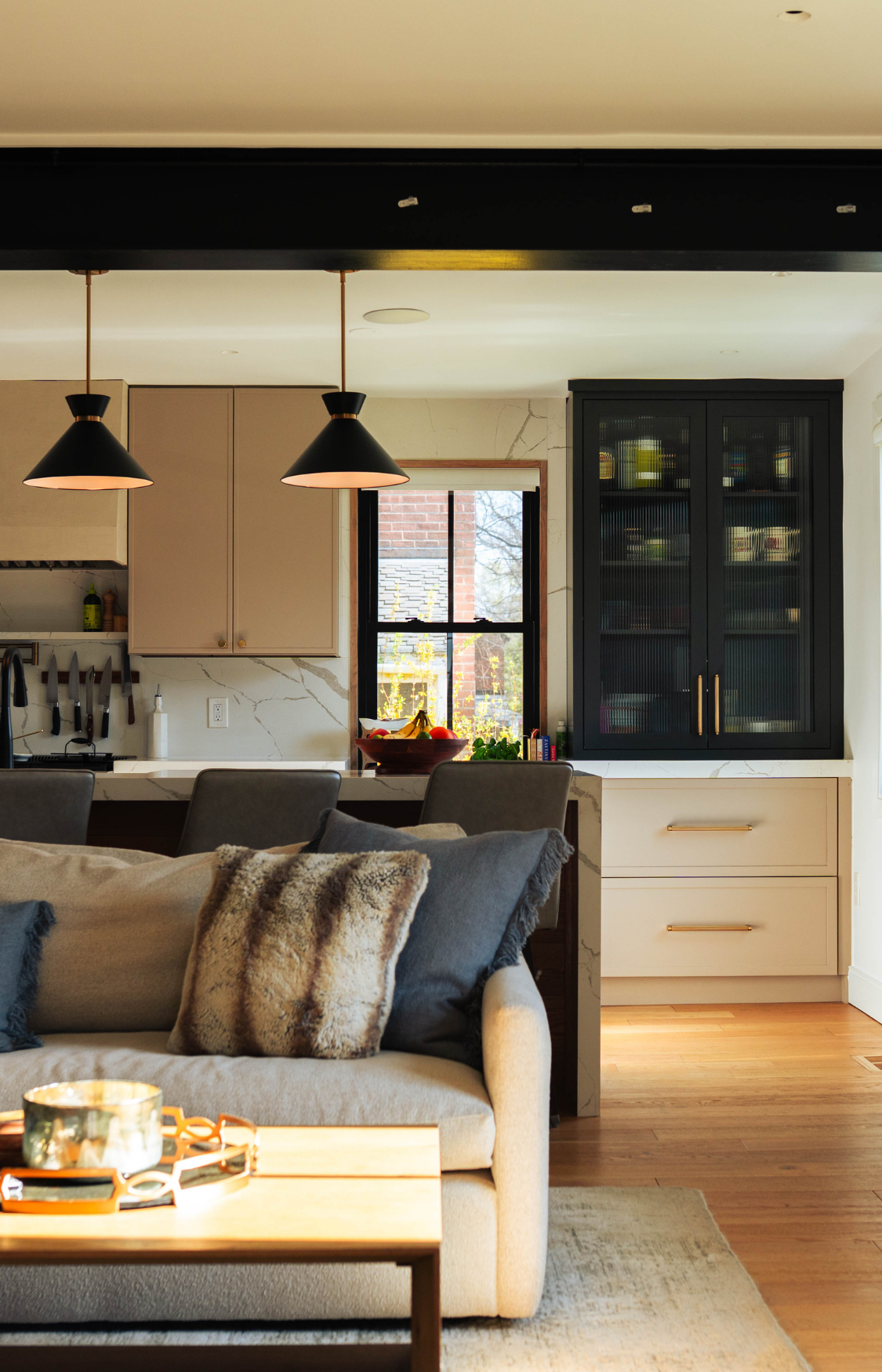 Open concept home remodel by Design Pro Remodeling featuring a modern kitchen, dining, and living space where walls were removed to create a seamless open floor plan with natural light, custom finishes, and connected living areas.