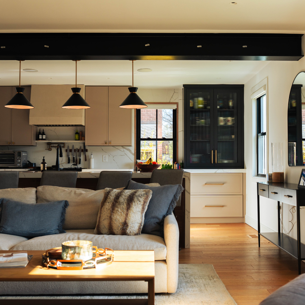 Open-concept home remodel with wide cased openings connecting kitchen, dining, and living room, creating clear sightlines from front to back